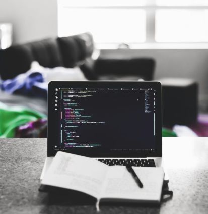 a laptop and a pen on a table